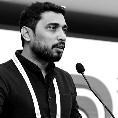 Chinmay Bhandari speaking at a podium